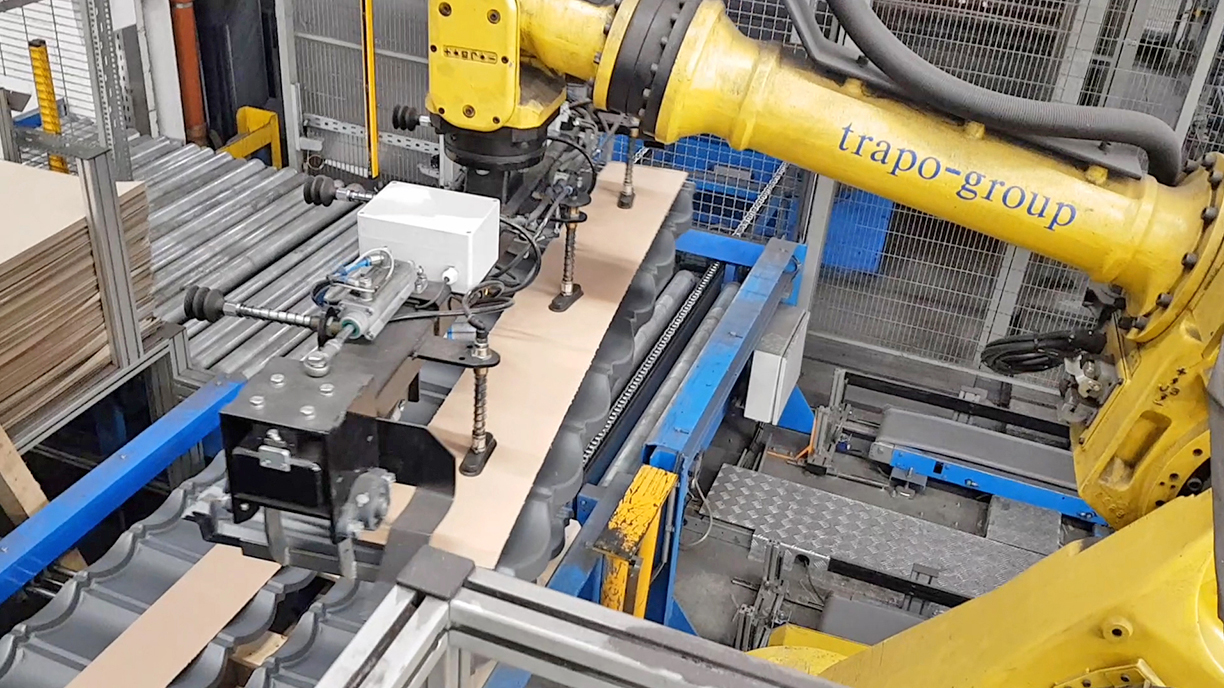 Multifunctional robot gripper for steel roof plates and protective slip sheets